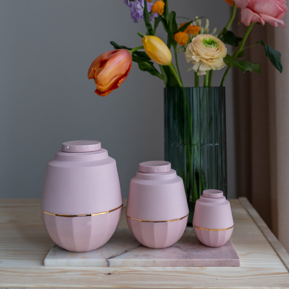 drie roze urntjes van groot naar klein